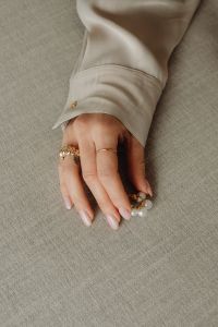 Kaboompics - Woman's Hand with Pearl Jewelry and Gold Rings