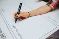 Kaboompics - Hand Writing on Blank Brainstorming Board with Copy Space