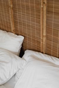 Kaboompics - Minimal White Bed with Bamboo Headboard