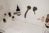 Kaboompics - Overhead Bathroom Sink Scene with Skincare Products and White Towel