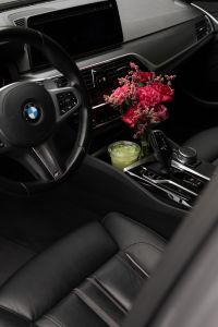Kaboompics - Pink Flowers and Matcha in a Black Car Interior