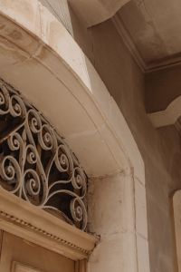 Kaboompics - Arched Stone Doorway with Wrought Iron Scroll Grille