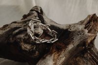 Kaboompics - Chunky Silver Link Bracelet Resting on Weathered Wood