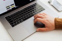 Kaboompics - Man works on a computer at his desk, mobile phone