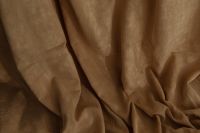 Kaboompics - Close-Up of Brown Curtain with Deep Diagonal Folds and Soft Shadows