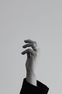 Kaboompics - Black and White Raised Hand with Layered Rings