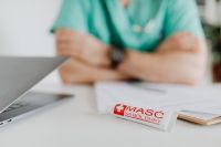 Kaboompics - Doctor Presenting Ointment Across Medical Desk