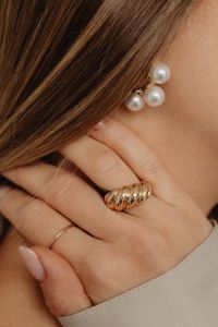 Kaboompics - Woman Wearing Pearl Cluster Stud Earrings and Stacked Gold Rings, Neutral Fashion Jewelry Close-Up