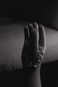 Kaboompics - Sculptural Black Hand Display with Pearl Rings in Dramatic Monochrome Light