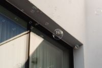 Kaboompics - Soap Bubbles against a Modern Glass Door and White Wall