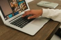 Kaboompics - Female Hand Working on Laptop Beside Open Notebook