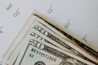 Kaboompics - Fanned US Dollar Banknotes on a Calendar, Cash and Budget Planning Flat Lay