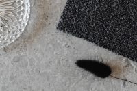 Kaboompics - Graphite Bouclé Upholstery Fabric Texture on Gray Stone