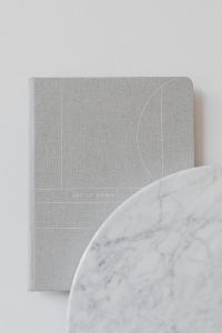 Kaboompics - Gray Linen Notebook Beside a Marble Disc for Minimal Stationery Mockups