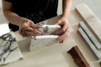 Kaboompics - Hands Holding a Marble Sample with Dried Botanical
