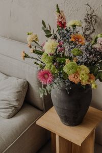 Kaboompics - Mixed Flower Bouquet Against Textured Beige Wall with Copy Space