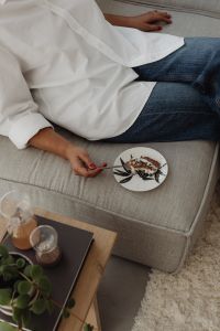 Kaboompics - Woman Eating Dessert on a Sofa Beside a Coffee Table