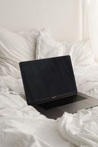 Kaboompics - Minimal Laptop Workspace on White Bedding