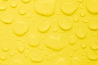 Kaboompics - Yellow Liquid Background With Soft Water Droplets