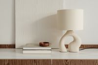 Kaboompics - Minimalist Ceramic Table Lamp and Wood Bowl on a Neutral Living Room Sideboard