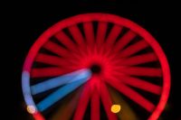 Kaboompics - Red Ferris Wheel with Blue Light Trails from the Lower Left
