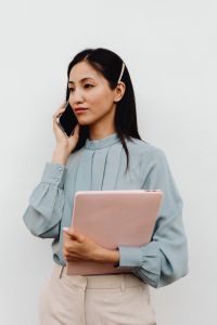Kaboompics - Asian Woman Balancing a Phone Call and Laptop Work