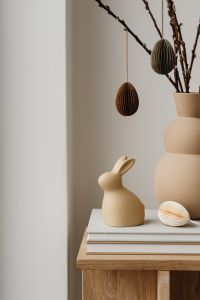 Kaboompics - Ceramic Easter Bunny And Paper Egg Decorations On Books