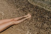 Kaboompics - Relaxing Bare Legs on a Textured Pebble Beach in Sardinia