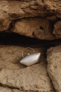 Kaboompics - Sculptural Pearl Minaudière Clutch in a Natural Rock Niche