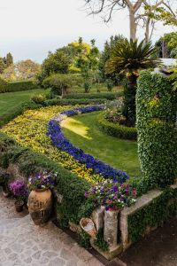 Kaboompics - Curved Yellow and Purple Flower Beds in an Italian Villa Garden