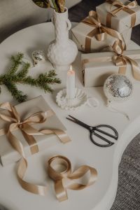 Kaboompics - Silver Christmas Bauble and Taper Candle with Neutral Wrapped Presents, Flat Lay