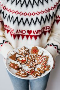 Kaboompics - Woman Holding Plate of Gingerbread Cookies