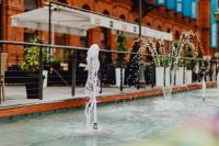 Kaboompics - Single Fountain Jet in Front of the Manufaktura Café Patio, Łódź