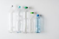 Kaboompics - Plastic Bottles in a Row on a White Marble Table