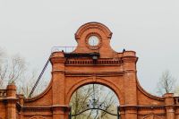 Kaboompics - Clock Tower and Ornate Brick Entrance Arch at Manufaktura in Łódź, Poland