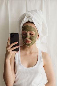Kaboompics - Selfie of Woman Wearing Green Clay Face Mask and White Towel
