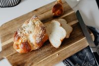 Kaboompics - Sliced Challah Loaf on Wooden Board With Knife