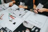 Kaboompics - Creative Team Reviewing Printed References and Planning Sheets