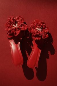 Kaboompics - Overhead Pair of Red Crochet-Flower Sandals on a Monochrome Red Background