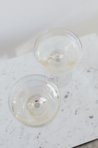 Kaboompics - Overhead Champagne Glasses on White Marble With Confetti