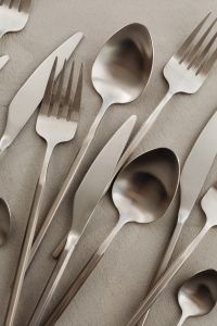 Kaboompics - Modern Silverware Arrangement with Forks, Spoons and Knives on Gray Texture