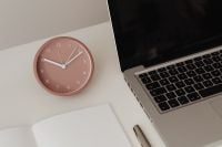 Kaboompics - Minimal Work Desk With Pink Clock and Laptop