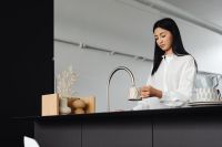 Kaboompics - Woman Filling a Cup at the Kitchen Sink