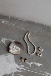 Kaboompics - Pearl Necklace and Earrings on Gray Concrete with a Seashell and Copy Space