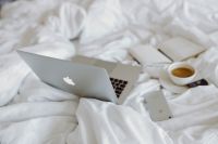 Kaboompics - Macbook, an iPhone, a coffee, a chocolate and a notebook in a bed