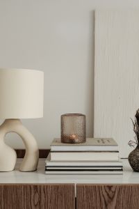 Kaboompics - Cozy Neutral Sideboard Styling with a Ceramic Lamp, Candle and Books