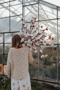 Kaboompics - A beautiful tall woman holds cotton branches