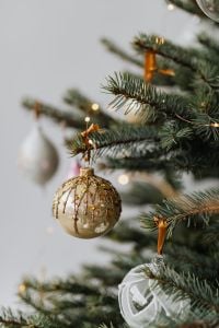 Kaboompics - Gold Glitter Bauble Hanging on Christmas Tree