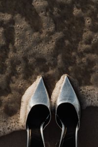 Kaboompics - Silver Pointed-Toe Heels beneath a Foamy Wave