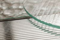 Kaboompics - Reflective Ribbed Glass Surface beneath a Curved Glass Edge
